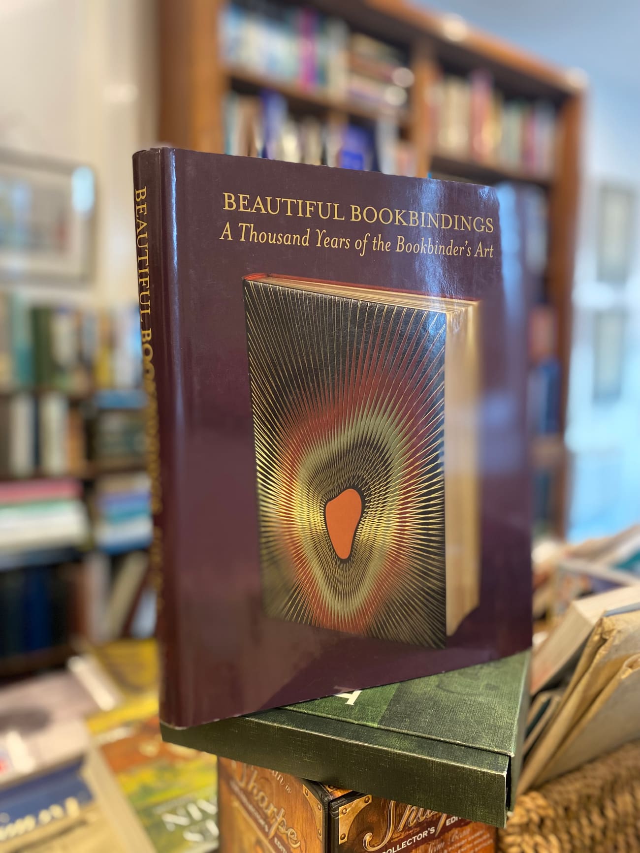 A close-up of a decorative book about bookbindings in the shop